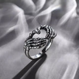 Daiiibabyyy  Vintage Punk Skull Hand with Heart-Shaped Ring for Men Women Hip Hop Gothic Skeleton Hand Ring Accessories Jewelry Gifts